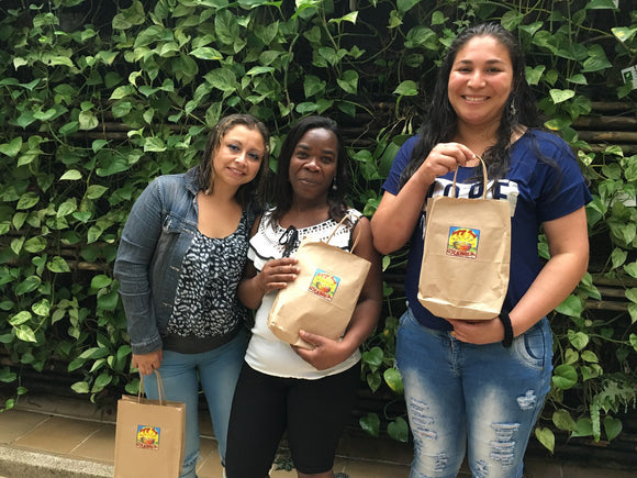 3 Colombian women receiving the profit-share from Singing Bowl Granola