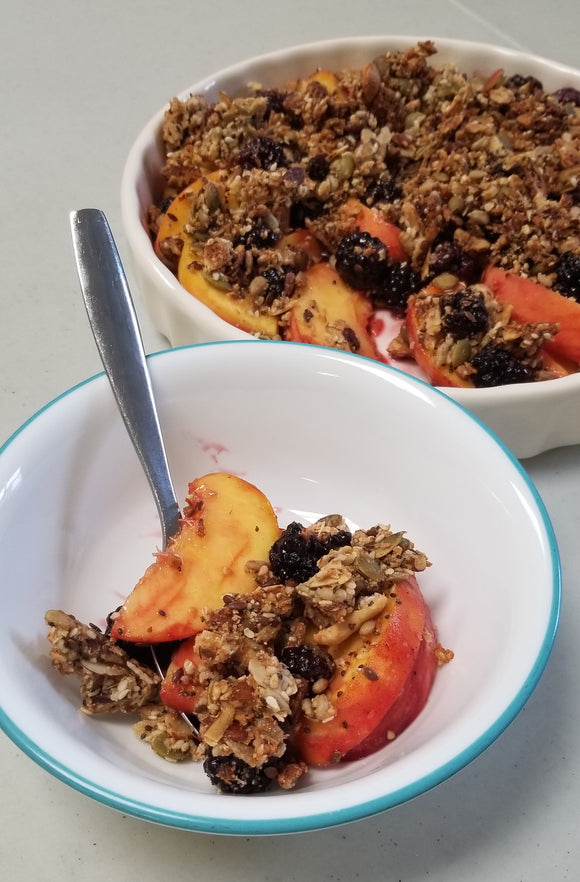 Peaches, blackberries and Singing Bowl No Grain Granola Crumble in a dish.